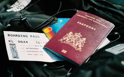 A passport with a boarding pass beside it