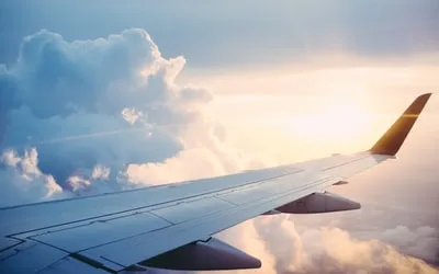 A plane wing above the clouds